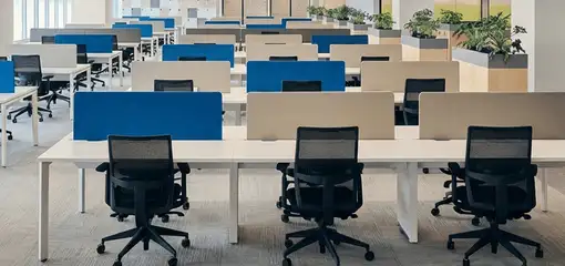 Modern open-plan office space featuring clean workstations, ergonomic chairs, and sanitized carpets provided by professional office cleaning services in Lakewood, CO.