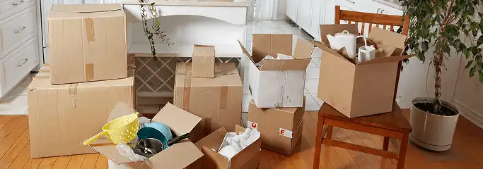 Packed moving boxes and household items in a kitchen before move-out or move-in cleaning, Lakewood, CO.